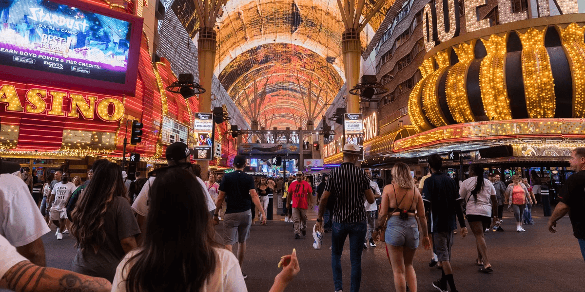 Crowd walking under bright lit canopies of Fremont Street in Las Vegas