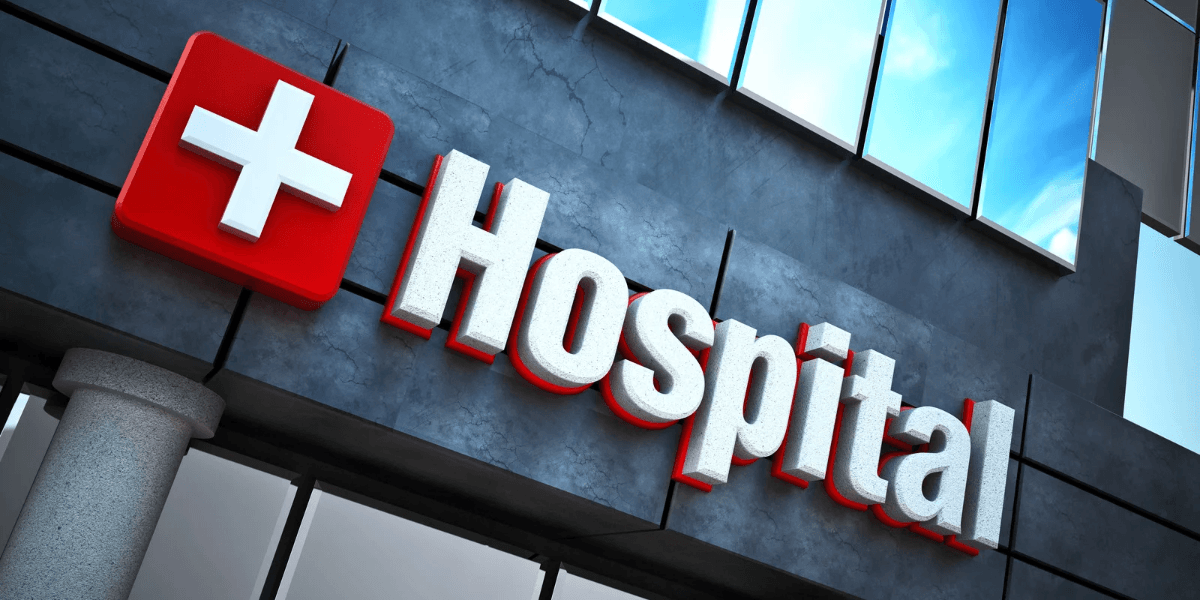 Sign of a hospital featuring a red cross and the word "Hospital" in bold letters